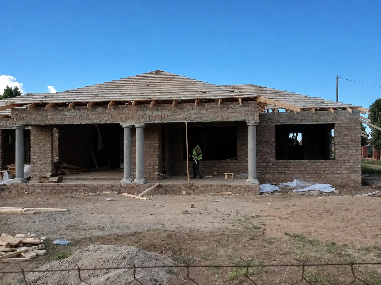 Brick structure with cast concrete pillars under construction